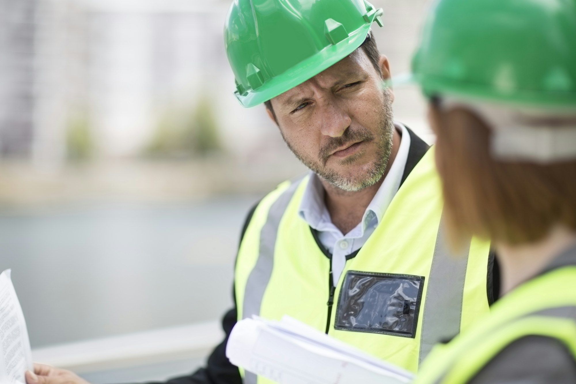 Manager and foreman discussing construction project on site
